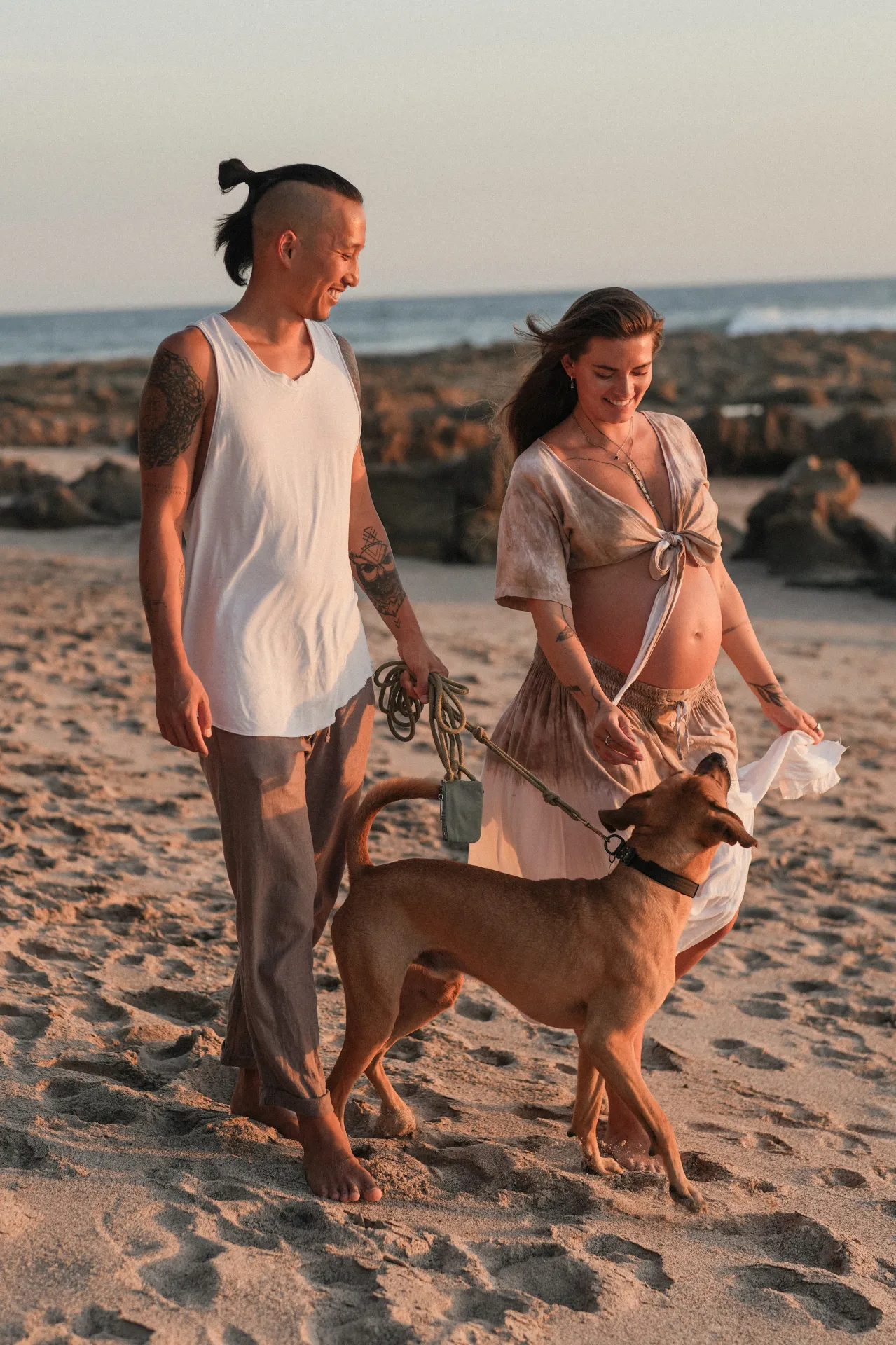 Ann-Christin and her partner walking their dog on the beach in Costa Rica